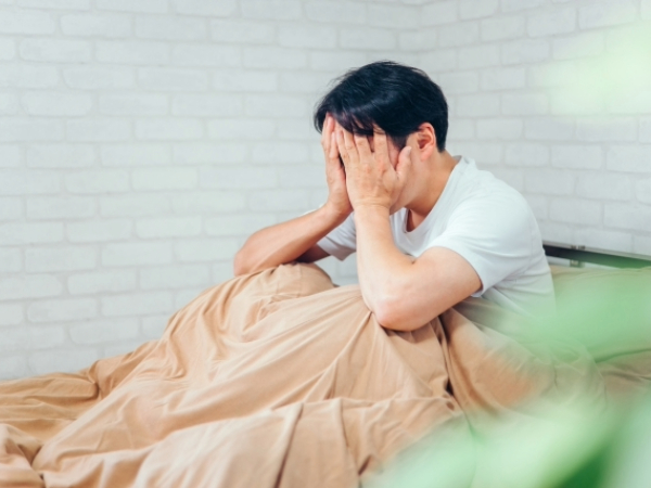 睡眠不足で体調が悪い男性のイメージ画像