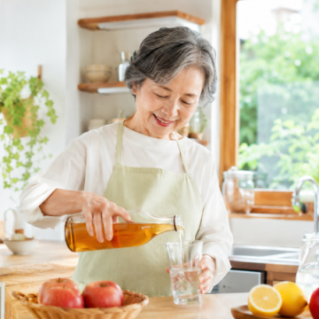 リンゴ酢を薄めているシニア女性のイメージ画像